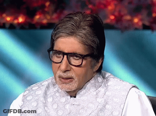 A Man With Glasses And A Beard Is Wearing A White Shirt GIF