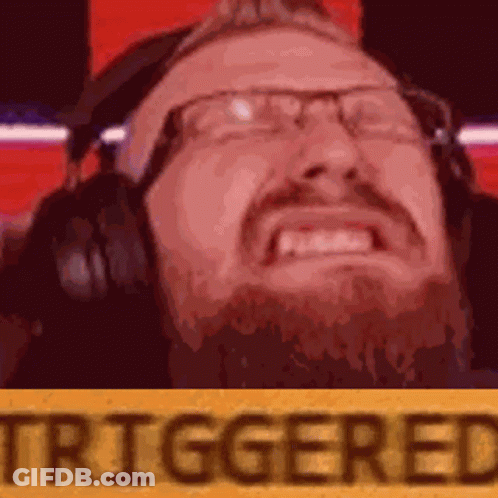 A Man With Glasses And A Beard Is Wearing Headphones And Making A Face . GIF