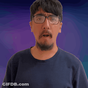 A Man With Glasses And A Beard Looks At The Camera GIF
