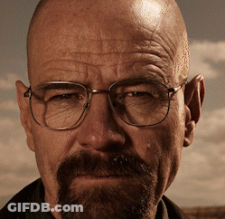 A Man With Glasses And A Beard Looks At The Camera With A Cloudy Sky In The Background GIF
