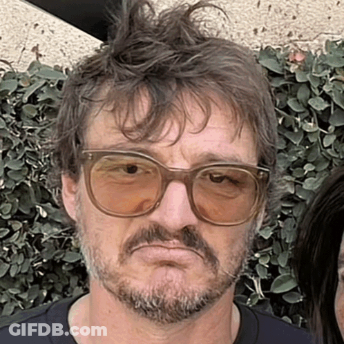 A Man With Glasses And A Beard Makes A Face GIF