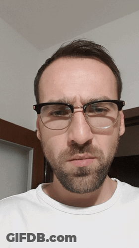 A Man With Glasses And A Beard Makes A Face GIF