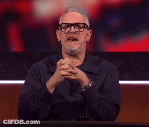 A Man With Glasses And A Beard Making A Devil Horns Gesture GIF