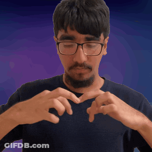 A Man With Glasses And A Beard Making A Heart With His Hands GIF