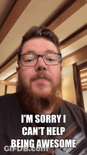 A Man With Glasses And A Beard Says Sorry I Can 'T Help Being Awesome GIF