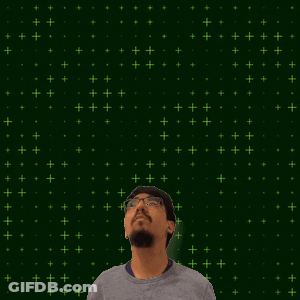 A Man With Glasses And A Beard Stands In Front Of A Green Background With 9 + 8 Written On It GIF