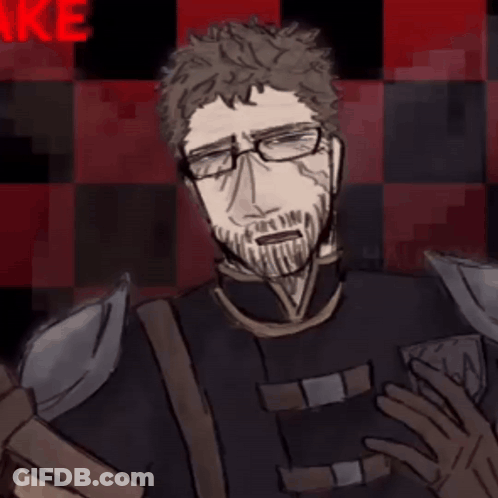 A Man With Glasses And A Beard Stands In Front Of A Red And Black Checkered Background With The Letter N On It GIF
