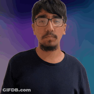 A Man With Glasses And A Beard Wearing A Black Shirt GIF