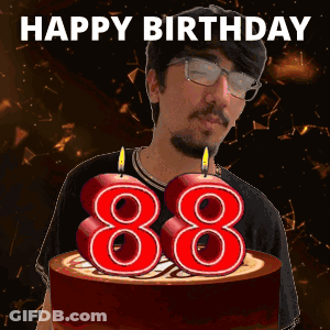 A Man With Glasses And A Birthday Cake With Candles In The Shape Of 88 GIF