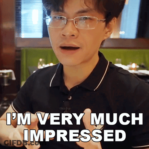 A Man With Glasses And A Black Shirt Says I 'M Very Much Impressed GIF