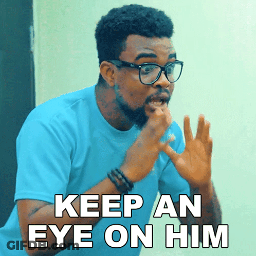 A Man With Glasses And A Blue Shirt Says " Keep An Eye On Him " GIF