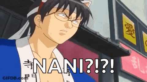 A Man With Glasses And A Cat Ear Headband Is Standing In Front Of A Building With The Word Nani Written On It . GIF