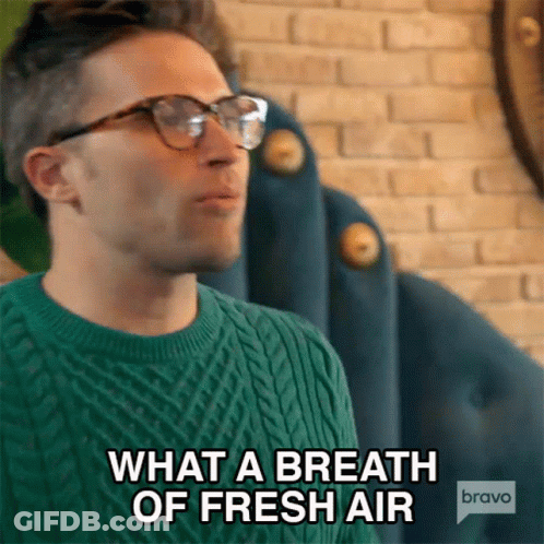 A Man With Glasses And A Green Sweater Says What A Breath Of Fresh Air GIF