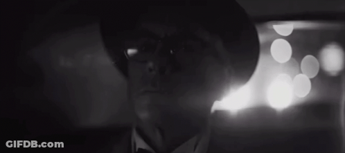 A Man With Glasses And A Hat Is Looking At The Camera GIF
