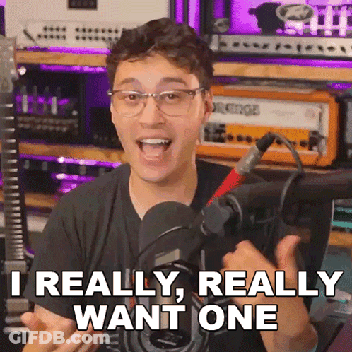 A Man With Glasses And A Microphone Says " Really Really Want One " GIF