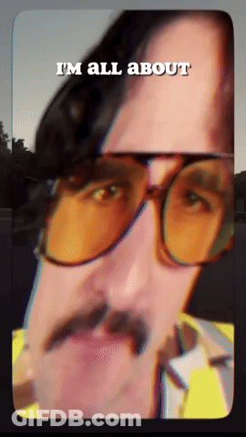 A Man With Glasses And A Mustache Has The Words I 'M All About Above His Head GIF