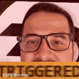 A Man With Glasses And A Mustache Is Holding A Sign That Says Triggered . GIF