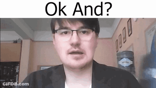 A Man With Glasses And A Mustache Is Looking At The Camera And Says `` Ok And ? '' . GIF
