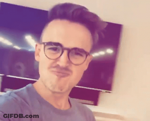 A Man With Glasses And A Mustache Is Making A Face GIF