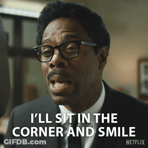 A Man With Glasses And A Mustache Is Saying I 'Ll Sit In The Corner And Smile GIF