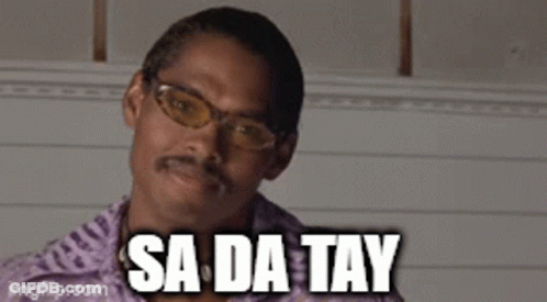 A Man With Glasses And A Mustache Is Saying Sa Da Tay . GIF