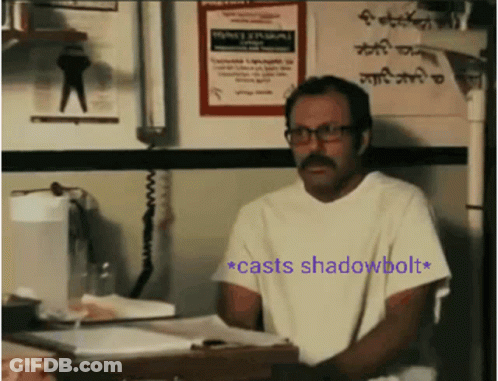 Man With Glasses And Mustache Sitting At Desk With Shadowbolt Sign GIF
