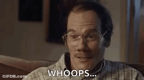 A Man With Glasses And A Mustache Is Sitting On A Couch And Making A Funny Face . GIF