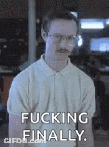 A Man With Glasses And A Mustache Is Standing In A Room With The Words `` Fucking Finally '' Written On His Face . GIF