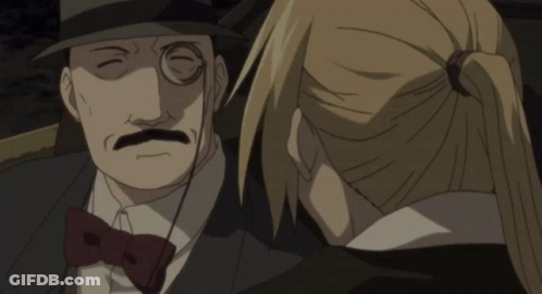 A Man With Glasses And A Mustache Is Talking To A Woman In A Ponytail GIF