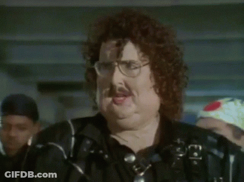 A Man With Glasses And A Mustache Is Wearing A Black Shirt GIF