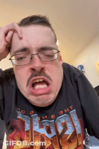 A Man With Glasses And A Mustache Is Wearing A Doom Shirt And Making A Funny Face GIF