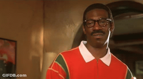 A Man With Glasses And A Mustache Is Wearing A Red Shirt And A White Collar . GIF