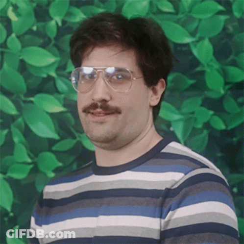 A Man With Glasses And A Mustache Is Wearing A Striped Sweater GIF
