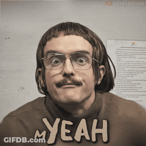 A Man With Glasses And A Mustache Is Wearing A Sweater That Says My Yeah GIF
