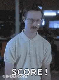 A Man With Glasses And A Mustache Is Wearing A White Shirt And Saying Score ! GIF
