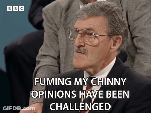 A Man With Glasses And A Mustache Says Fuming My Chinky Opinions Have Been Challenged GIF