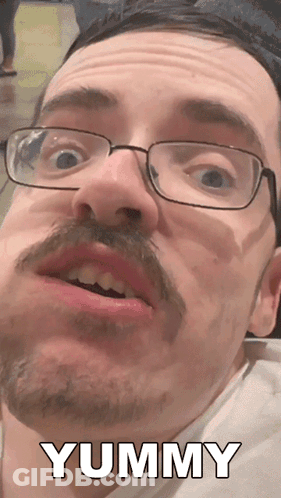 A Man With Glasses And A Mustache Says Yummy In White Letters GIF