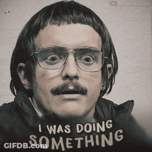 A Man With Glasses And A Mustache Wears A Shirt That Says I Was Doing Something GIF