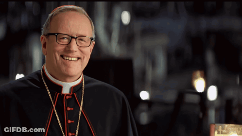 A Man With Glasses And A Purple Hat Smiles For The Camera GIF