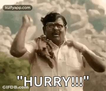 A Man With Glasses And A Scarf Around His Neck Is Making A Funny Face And Saying `` Hurry ! '' GIF