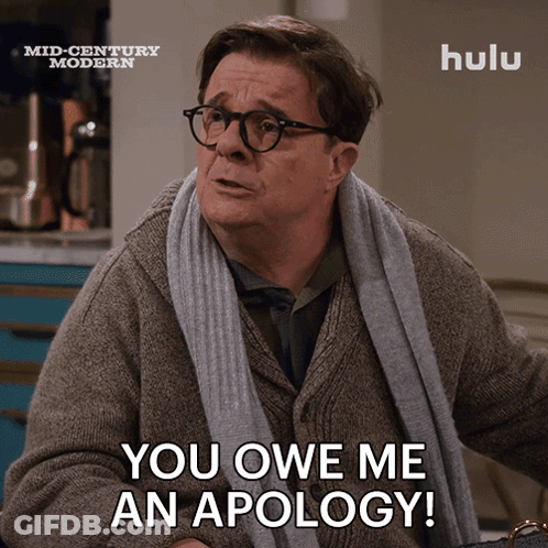Man With Glasses And Scarf Saying You Owe Me An Apology GIF