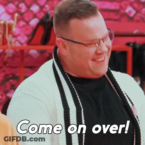 A Man With Glasses And A Scarf Is Smiling And Says Come On Over GIF