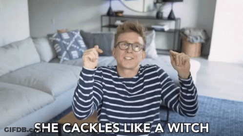 A Man With Glasses And A Striped Shirt Says She Cackle Like A Witch GIF