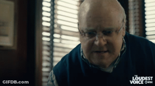 A Man With Glasses And A Sweater That Says The Loudest Voice GIF