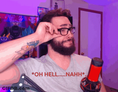 A Man With Glasses And A Tattoo On His Arm Is Standing In Front Of A Microphone And Says Oh Hell Nahh GIF