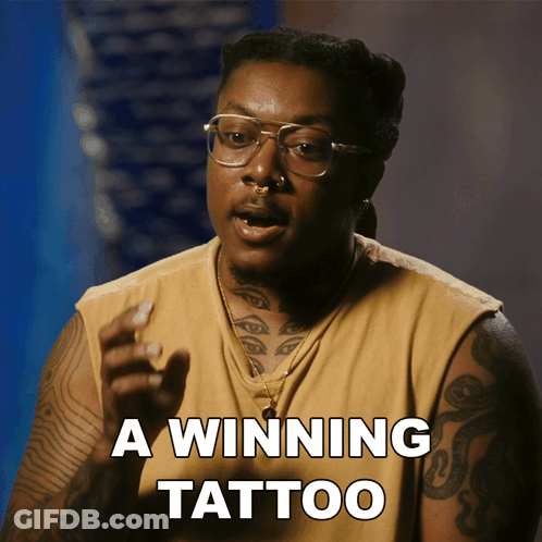 A Man With Glasses And A Tattoo On His Arm Says " A Winning Tattoo " GIF
