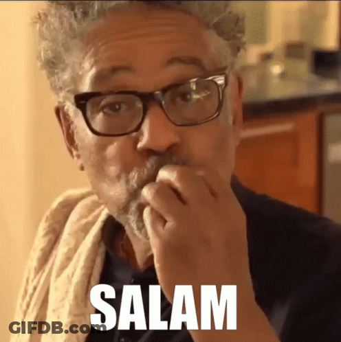 A Man With Glasses And A Towel Around His Neck Is Eating Something And The Word Salam Is Above Him GIF