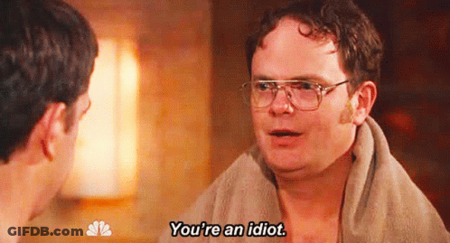 A Man With Glasses And A Towel Around His Neck Is Saying You 'Re An Idiot . GIF