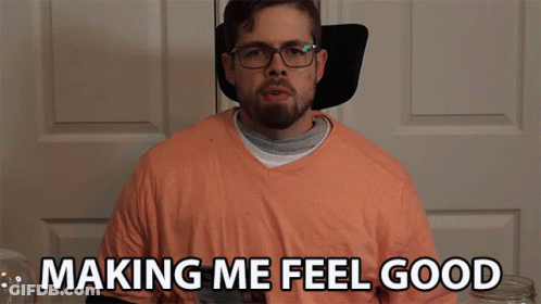 Man With Glasses And Orange Shirt Says Making Me Feel Good GIF