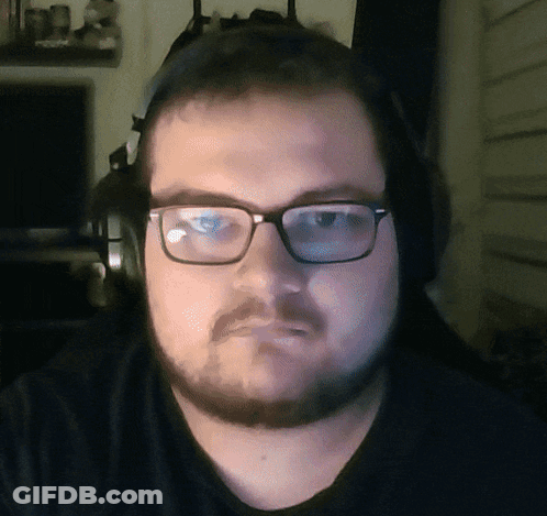 A Man With Glasses And Headphones Looks At The Camera GIF